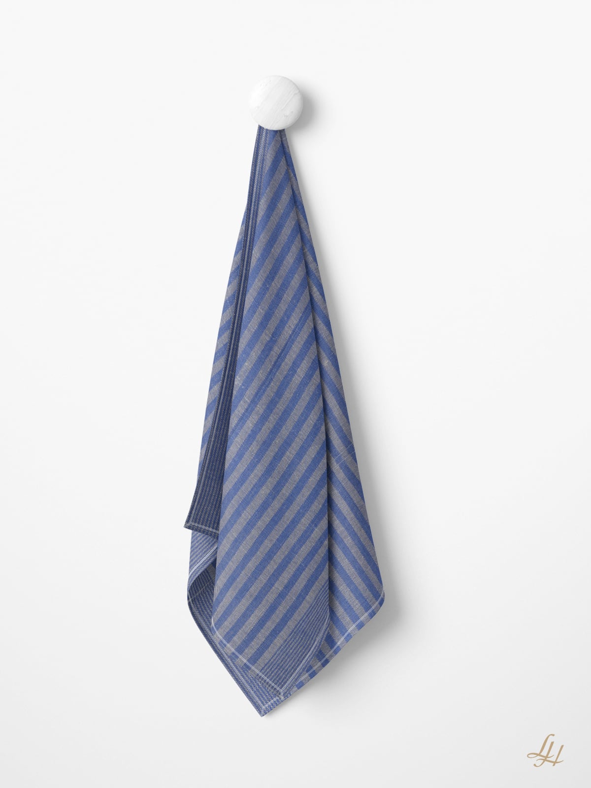 Ein Grubentuch blau gestreiftes Küchentuch hängt an einem weißen runden Haken an einer schlichten weißen Wand.