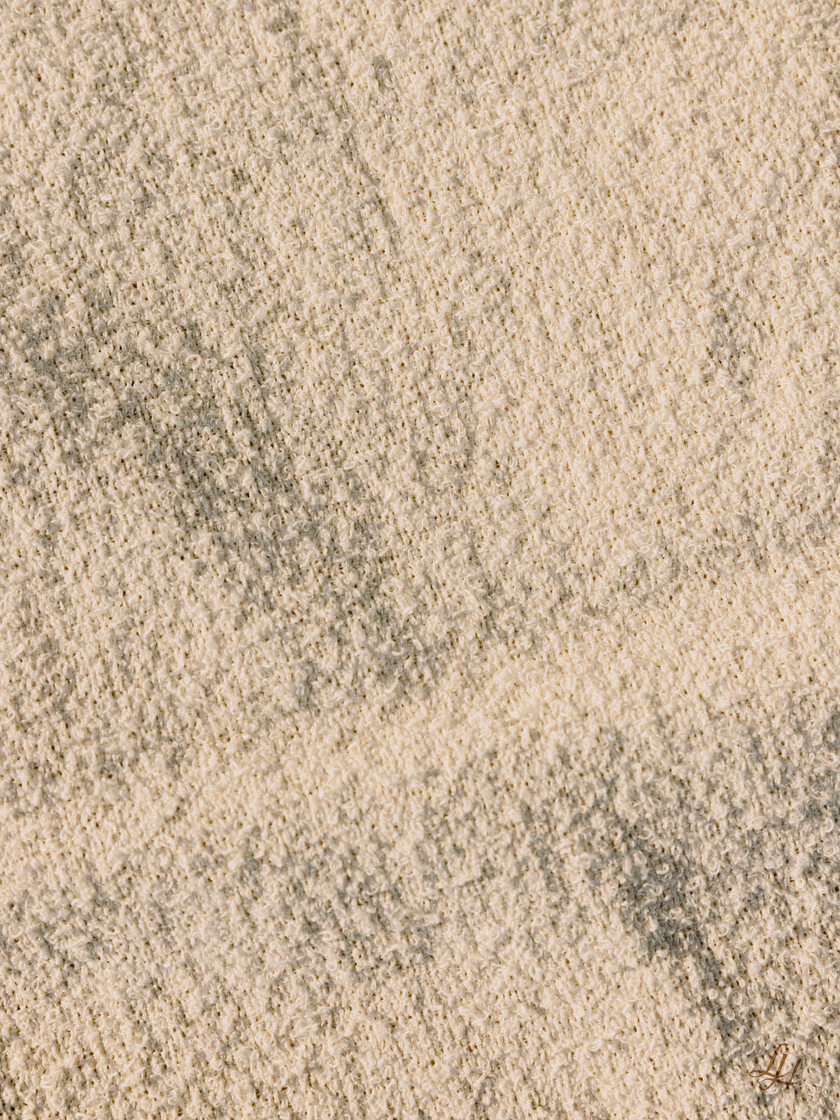 Nahaufnahme von strukturiertem Sand mit schwachen Linien, die an die natürlichen Muster in Leinenfrotté-Saunatüchern aus europäischem Leinen erinnern.