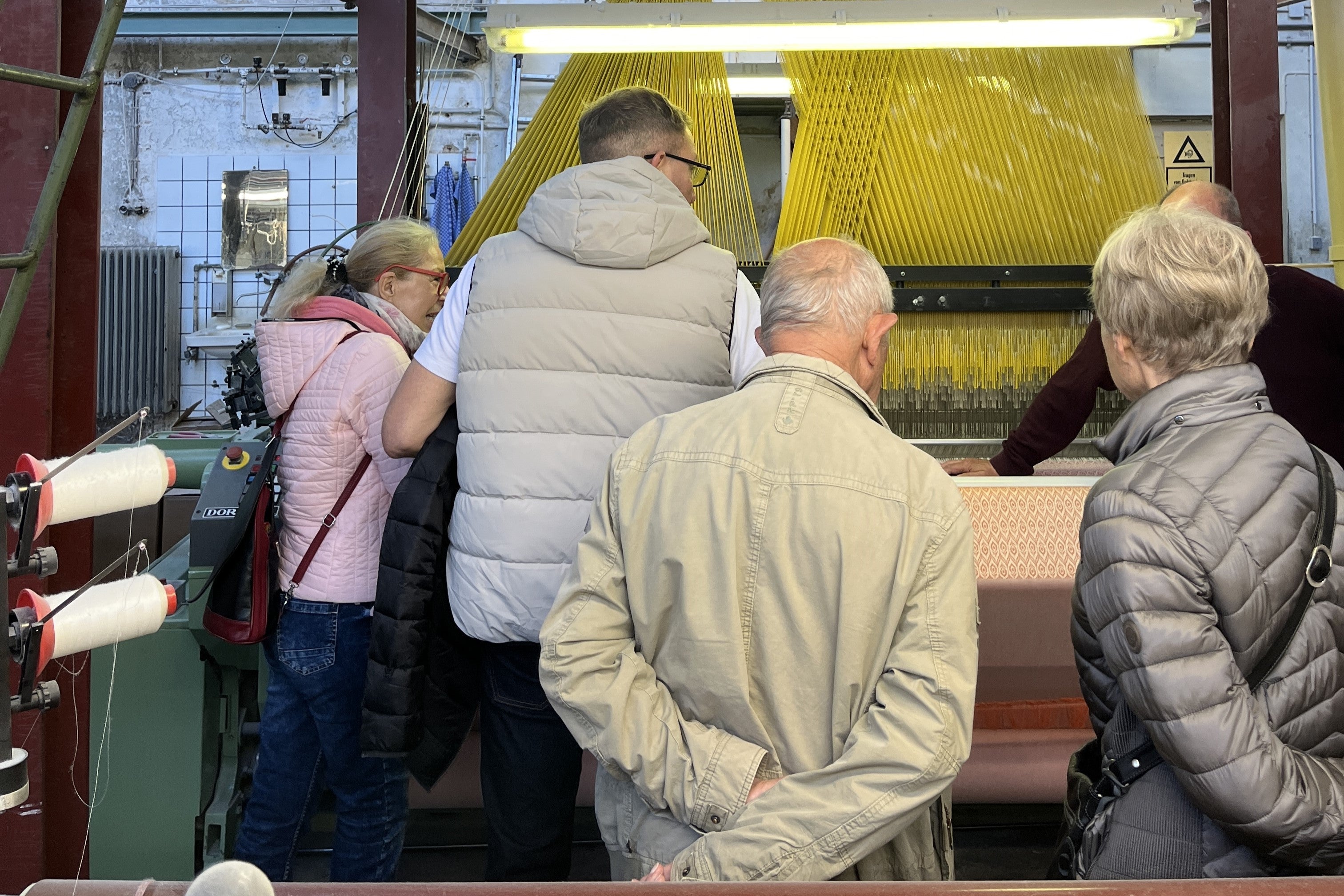 Besucher der Europäischen Tage des Kunsthandwerks an einer Jaquardmaschine der Leinenweberei Hoffmann